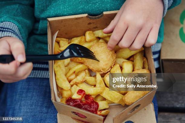 child eating a takeaway at the beach - unhealthy eating stock pictures, royalty-free photos & images