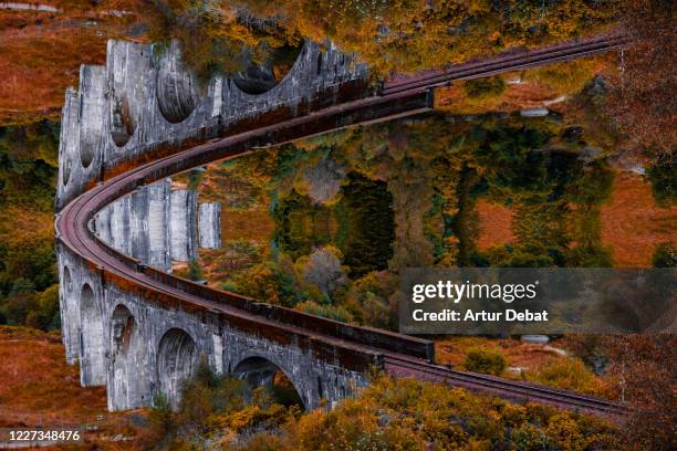 surreal picture with mirror effect of stunning bridge with moebius effect. - glenfinnan viaduct stockfoto's en -beelden