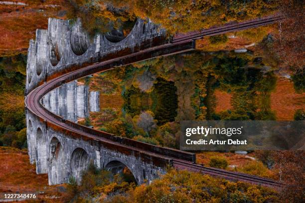 surreal picture with mirror effect of stunning bridge with moebius effect. - glenfinnan viaduct stock pictures, royalty-free photos & images