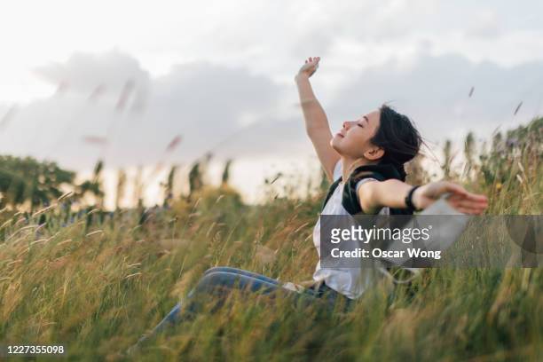 young woman taking a breath of fresh air after passing coronavirus - air pollution mask stockfoto's en -beelden