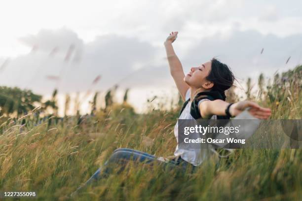 young woman taking a breath of fresh air after passing coronavirus - air pollution health stock pictures, royalty-free photos & images
