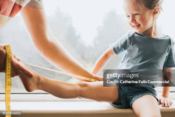 measuring a child's leg - mannequin legs stock pictures, royalty-free photos & images