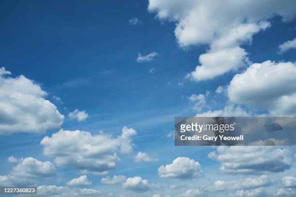 fluffy white clouds and blue sky - wolkengebilde stock-fotos und bilder