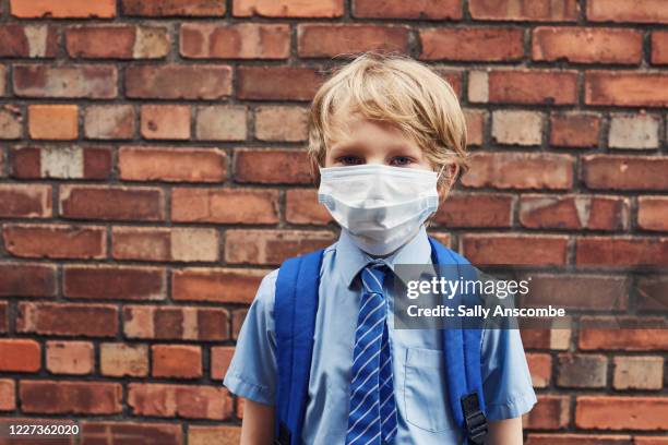 school child wearing a face mask - protective face mask stock pictures, royalty-free photos & images