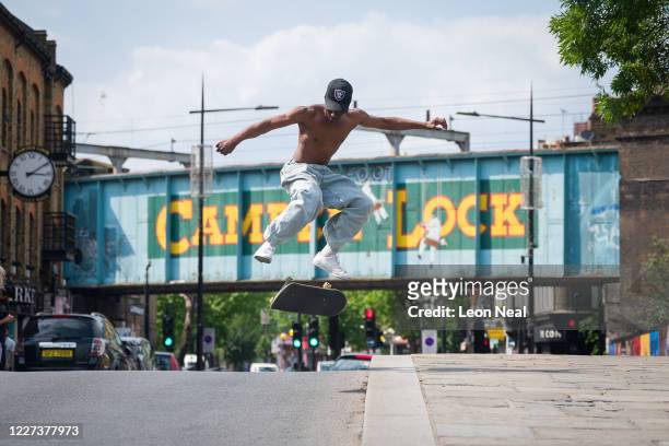 Skateboarder from the Apex Mafia takes advantage of the relaxation of lockdown guidance to perform tricks in the road near Camden Lock on May 27,...
