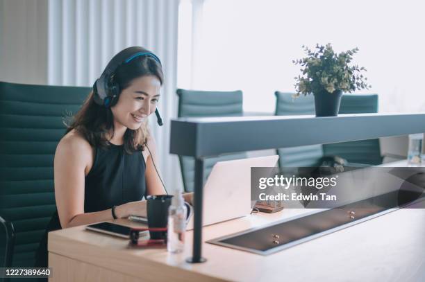 an asian chinese beautiful woman white collar worker talking to the camera video calling video conference with his business partners  with face mask - virtual coach stock pictures, royalty-free photos & images