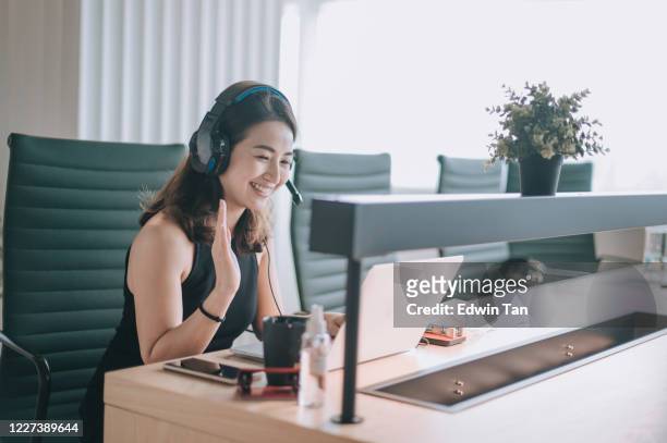 an asian chinese beautiful woman white collar worker talking to the camera video calling video conference with his business partners  with face mask - camera operator imagens e fotografias de stock