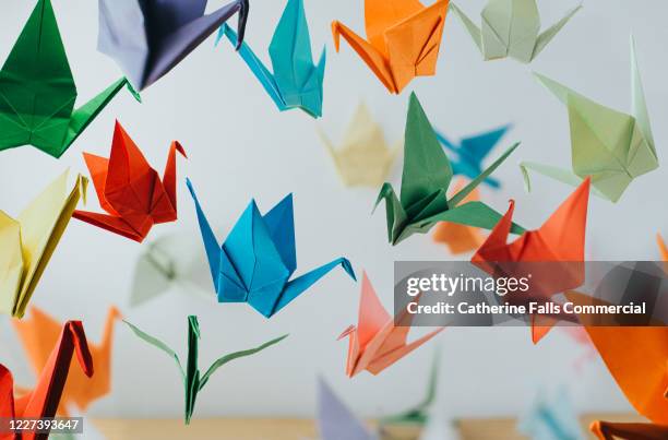 paper cranes - flock stock pictures, royalty-free photos & images