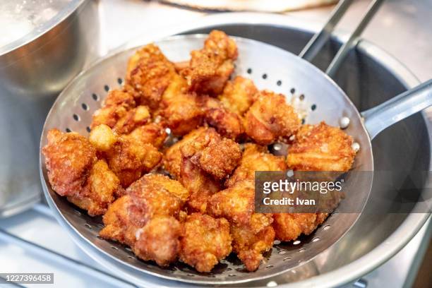 chief making the dish, deep fried chicken in iron pan - karaage stock pictures, royalty-free photos & images