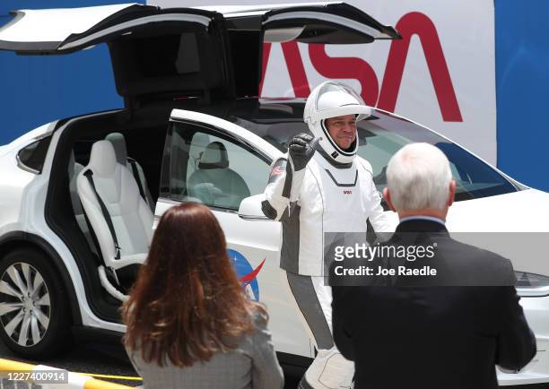 Vice President Mike Pence and his wife Karen Pence watch as NASA astronaut Bob Behnken walks out of the Operations and Checkout Building on their way...