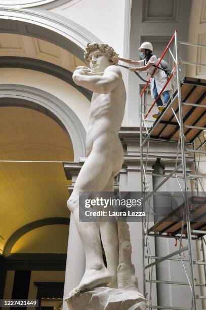 Restorer cleans Michelangelo's David statue while preparing for the reopening of the Galleria dell'Accademia which was closed for almost three months...