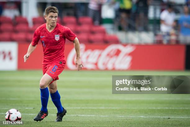 Wil Trapp of the United States with the ball in front of him and the Coca-Cola logo behind him during the International Friendly match between the...