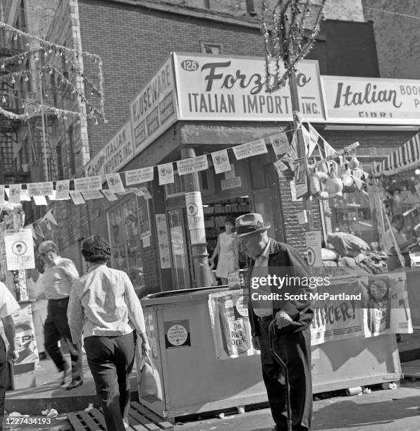 View of a senior adult using a walking cane, among other people, on Mulberry Street during the Feast Of San Gennaro Festival, in the Little Italy...