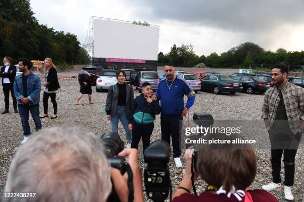 July 2020, Bavaria, Munich: The leading actress Emma Drogunova, director and leading actor Kida Khodr Ramadan and his son "Momo" pose before the...