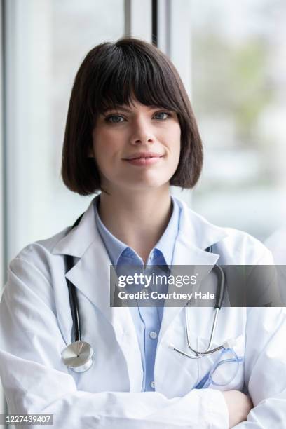 Doctor High Resolution Professional Young Adult Doctor Smiles While Looking At Camera High-Res ...