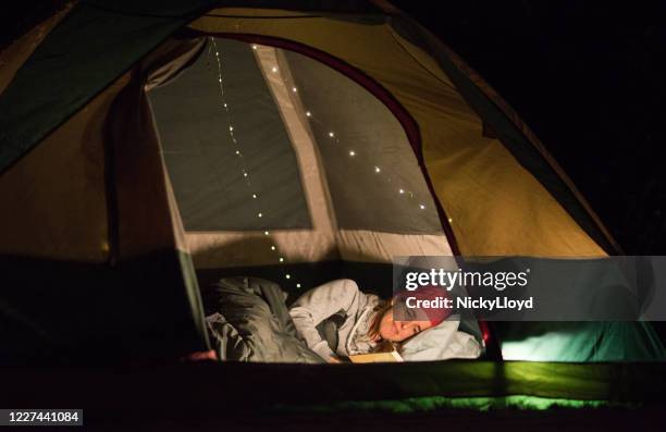 she loves to read at night - sleeping in tent stock pictures, royalty-free photos & images