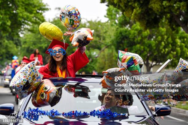 Natalie Khay is all smiles as she joins hundreds of fellow Los Alamitos High School graduates in a car parade through Rossmoor in unincorporated...