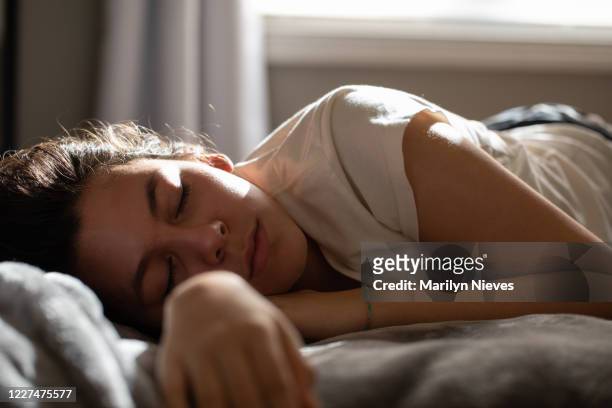 teenager falls asleep while studying in bed