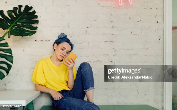 young eclectic woman checking phone - blue hair stock pictures, royalty-free photos & images