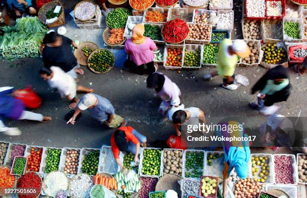 blurred motion of people at vegetable market - jakarta stock pictures, royalty-free photos & images