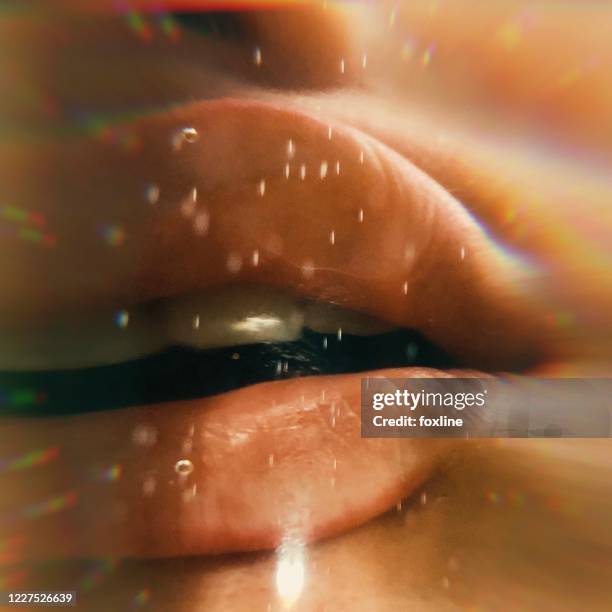 close-up of a woman's lips pressed against glass - extreme close up kiss stock pictures, royalty-free photos & images