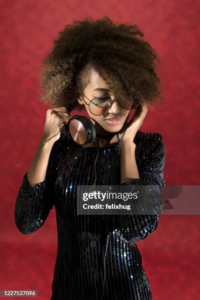 portrait of a beautiful woman with headphones around her neck - headphone man on neck stock-fotos und bilder