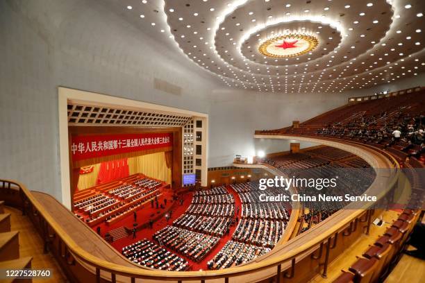 Deputies attend the closing meeting of the third session of the 13th National People's Congress at the Great Hall of the People on May 28, 2020 in...