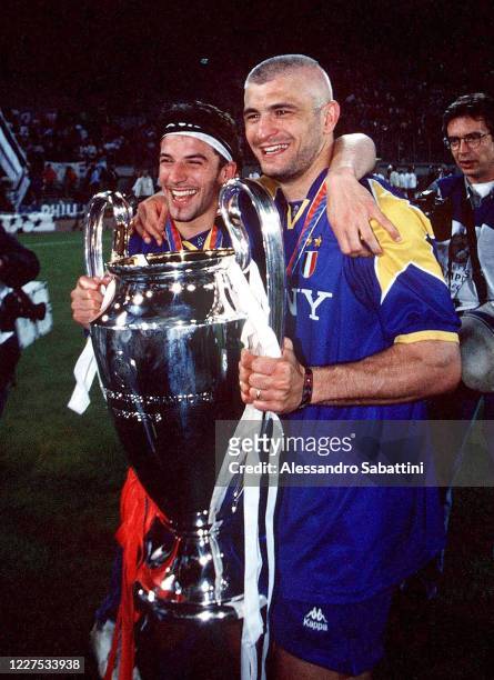Alessandro Del Piero and Fabrizio Ravanelli of Juventus celebrate the victory with the trophy after the UEFA Champions League 1995-1996 match between...