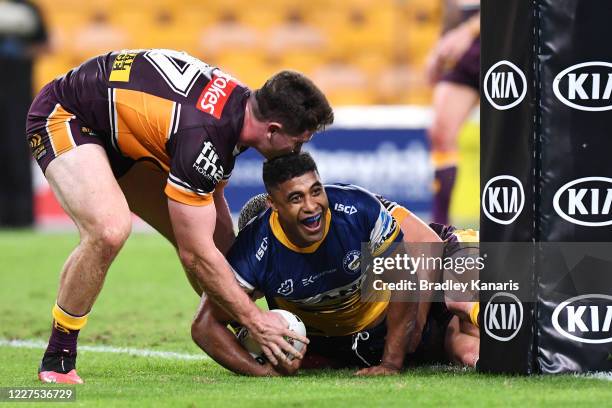 Michael Jennings of the Eels scores a try during the round three NRL match between the Brisbane Broncos and the Parramatta Eels at Suncorp Stadium on...