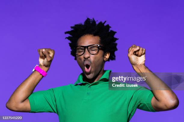 colored portrait of excited young man with dreadkocks - purple shirt stock pictures, royalty-free photos & images
