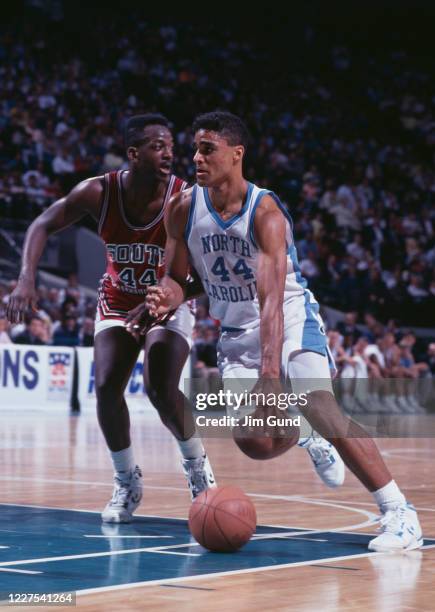 Rick Fox, Forward for the University of North Carolina Tar Heels dribbles the ball past Jo Jo English of the University of South Carolina Gamecocks...