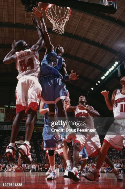 Antawn Jamison, Forward for the University of North Carolina Tar Heels attempts to block Obinna Ekezie, Center for the University of Maryland...