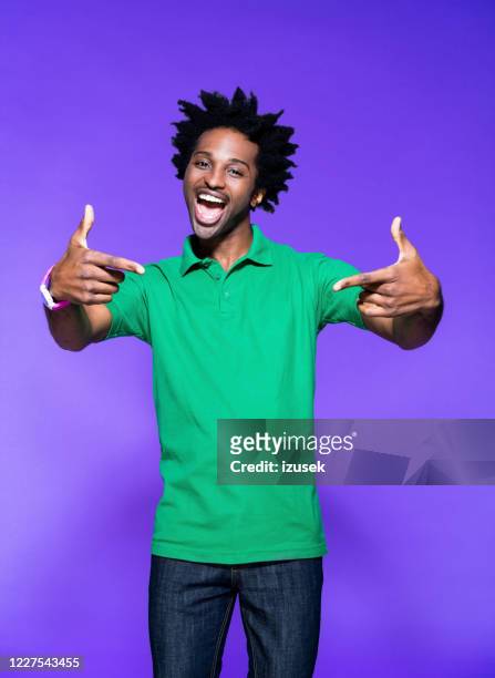 colored portrait of excited young man - guy pointing stock pictures, royalty-free photos & images
