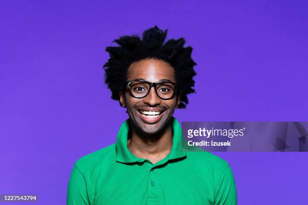 colored portrait of excited young man with dreadkocks looking away - portrait studio purple background stock pictures, royalty-free photos & images