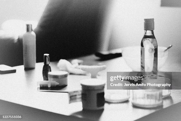 table with alcohol, pills and bottles on it - aschenbecher stock-fotos und bilder