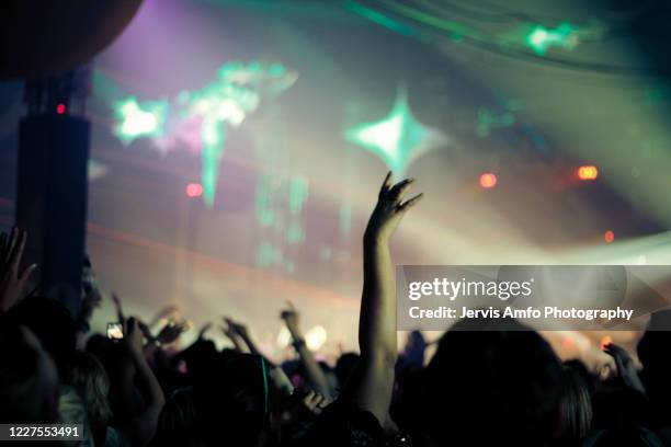 hands up enjoying a music concert - concert hands stock pictures, royalty-free photos & images