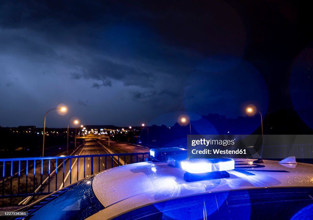 Spain, Madrid,Close-upof police emergency lights glowing during night intervention