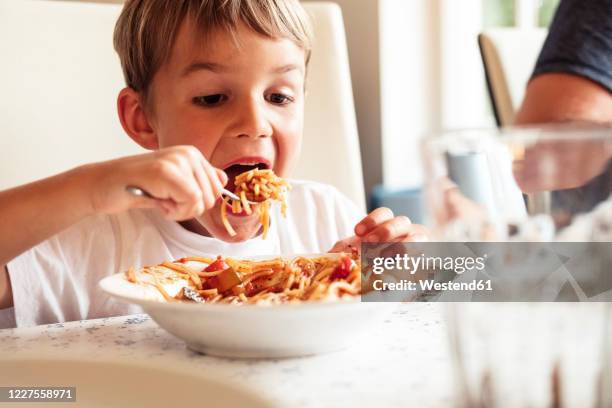 portrait of boy eating spaghetti - the joys of eating spaghetti stock pictures, royalty-free photos & images