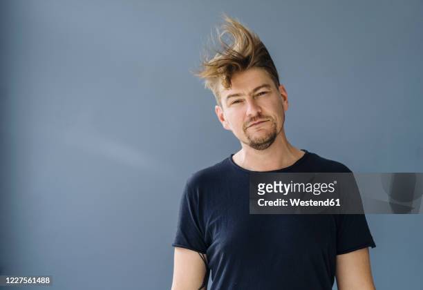 portrait of a bearded man with tousled hair - vento foto e immagini stock
