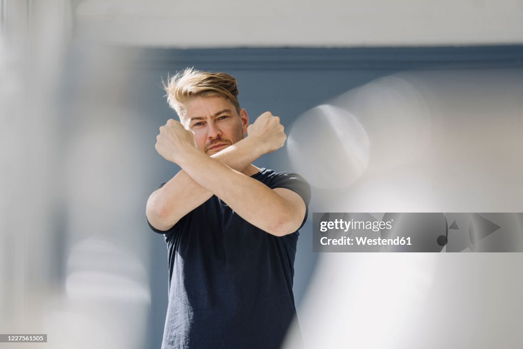 Portrait of a bearded man crossing his arms