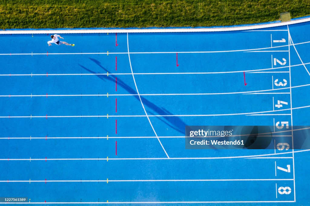 Top view of runner on blue tartan track