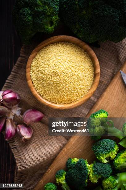 bowl of couscous, garlic and fresh broccoli - クスクス ストックフォトと画像