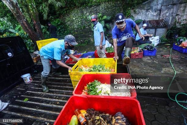 Workers prepare feed to be given to animals at the zoo in Bandung, West Java, Indonesia, May 4, 2020. Based on data from the Indonesian Zoo Society,...