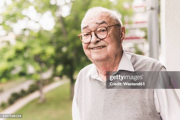 portrait of smiling senior man wearing glasses - male looking content stock pictures, royalty-free photos & images