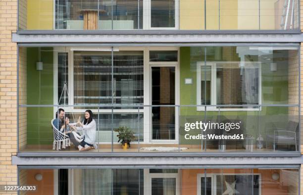 family spending time together on balcony - vizinho imagens e fotografias de stock