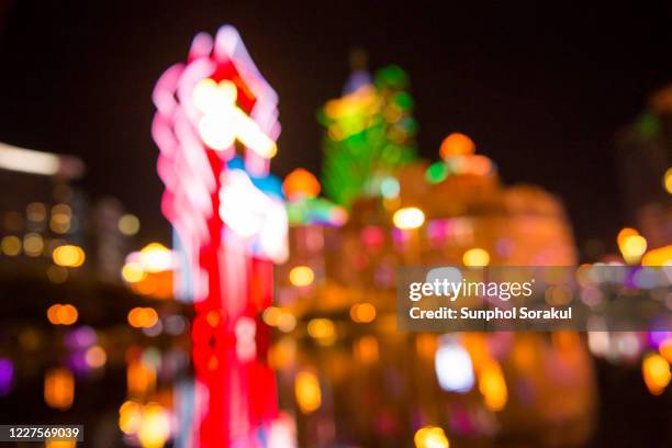 a blur background image of macau casino colour neon signage - casino sign stock pictures, royalty-free photos & images