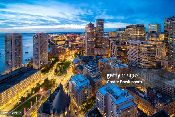 aerial view of boston harbor and financial district at sunset in boston, massachusetts, usa. - boston aerial stock pictures, royalty-free photos & images