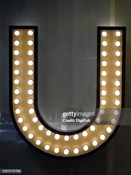 single letter "u" - light letters stock-fotos und bilder