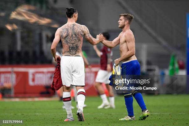 Zlatan Ibrahimovic of AC Milan shakes hands with Riccardo Gagliolo of Parma Calcio prior to exchanging jerseys at the end of the Serie A football...