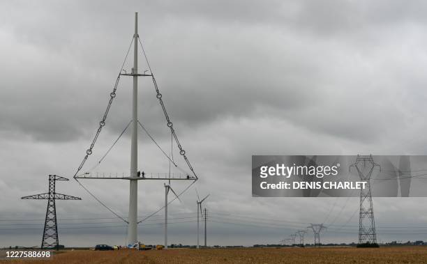 An image of the new electricity pylon installed by RTE near the town of Flers in Escrebieux, northern France on July 16, 2020. - A central mast and a...